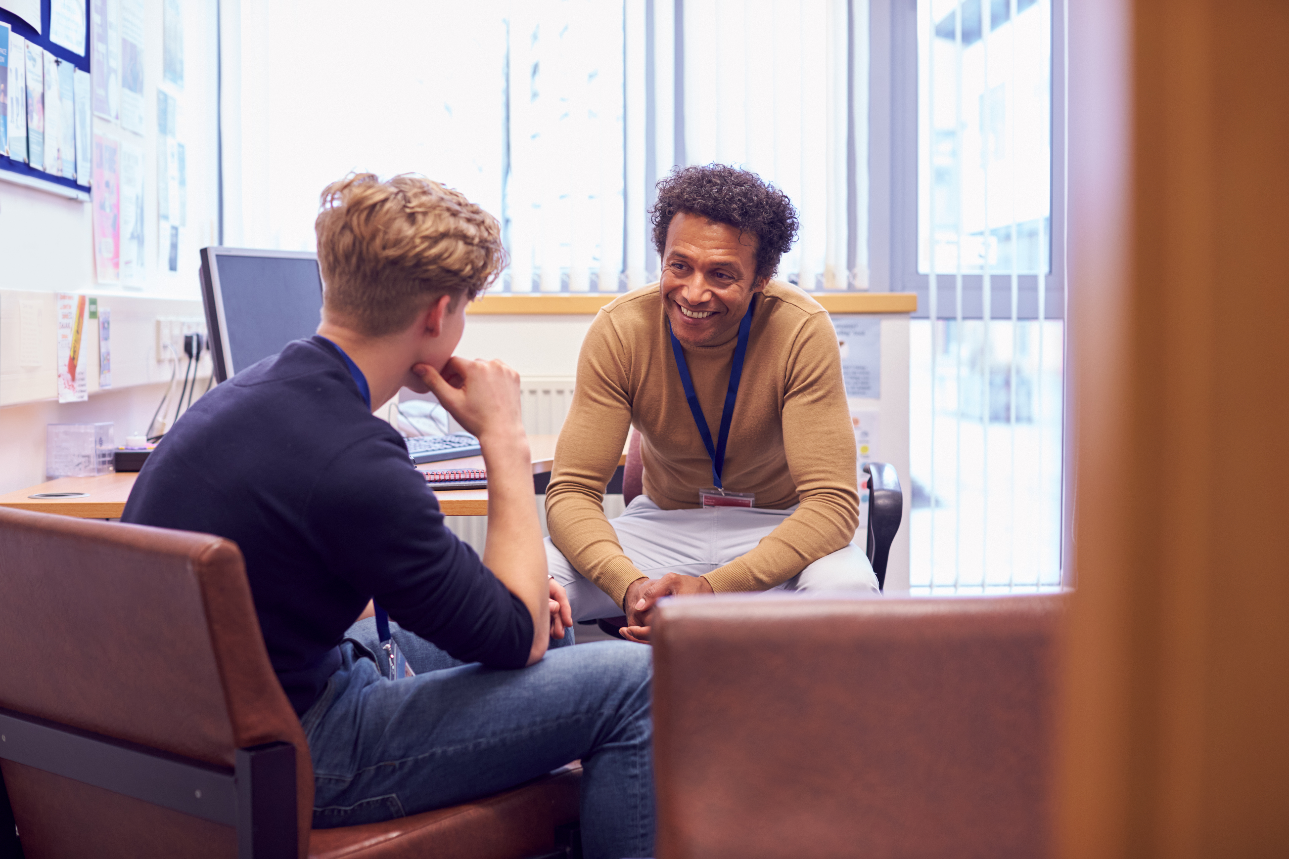 A professional mentoring a student in a one-on-one conversation
